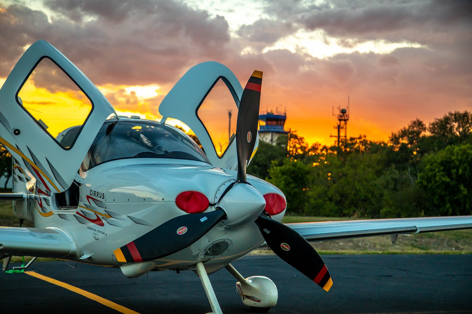 The owner's 2007 Cirrus SR22 (tail N622AD, SE22) with racing stripes, door open at sunset